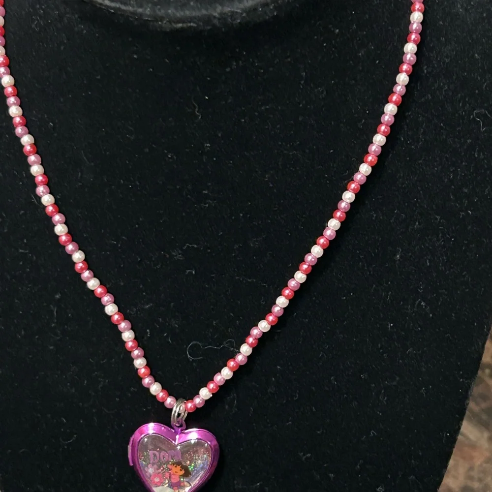 Pink and white beaded necklace with Dora the Explorer locket